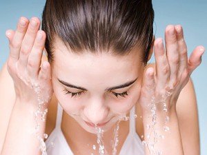 woman-splashing-face-with-water-surprising-acne-facts-full-dg-pg